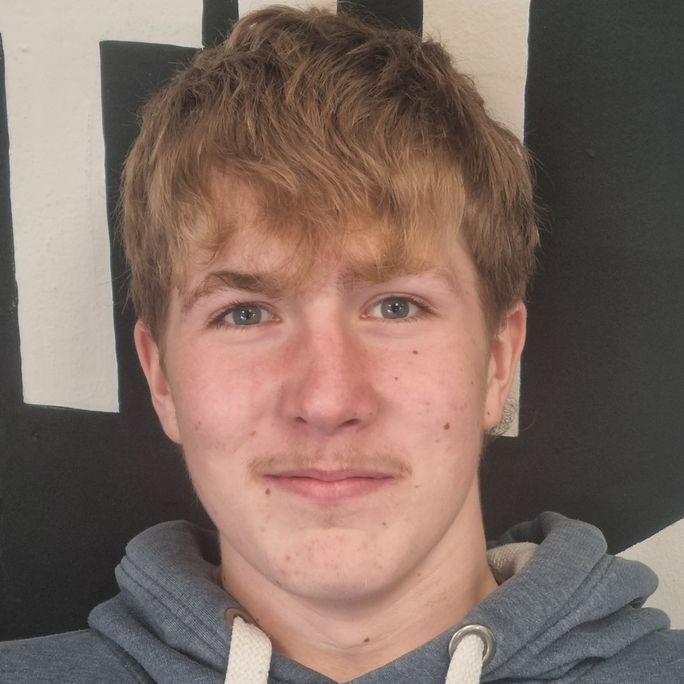 Photo of young man, smiling to camera.